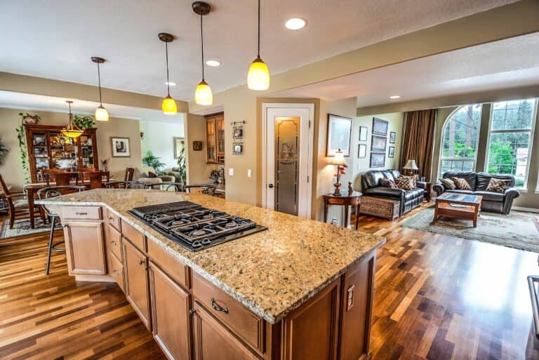 Open-concept residential kitchen and living room with hardwood floors and modern finishes